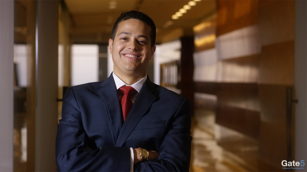 man smiling at camera in an office for a promotional video