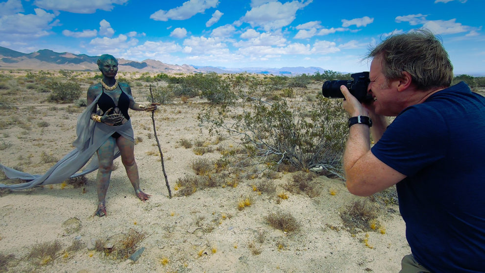 film director Greg McDonald photographs alien in behind the scenes