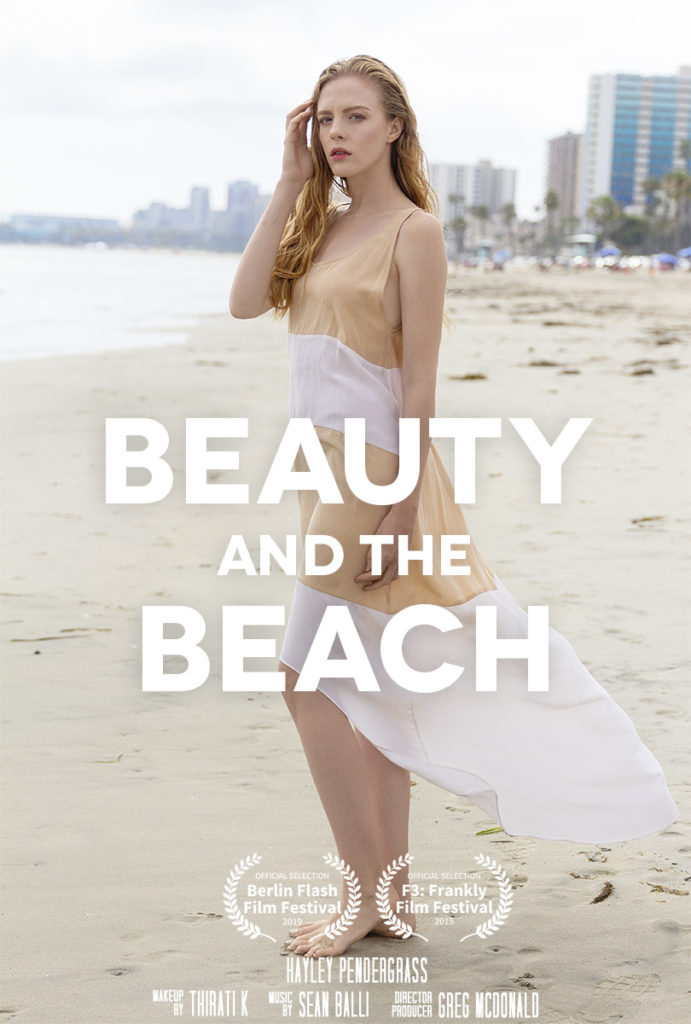 woman in a pretty dress stands on the beach in the eco fashion film, Beauty And The Beach