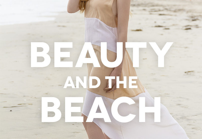 woman in a pretty dress stands on the beach in the eco fashion film, Beauty And The Beach
